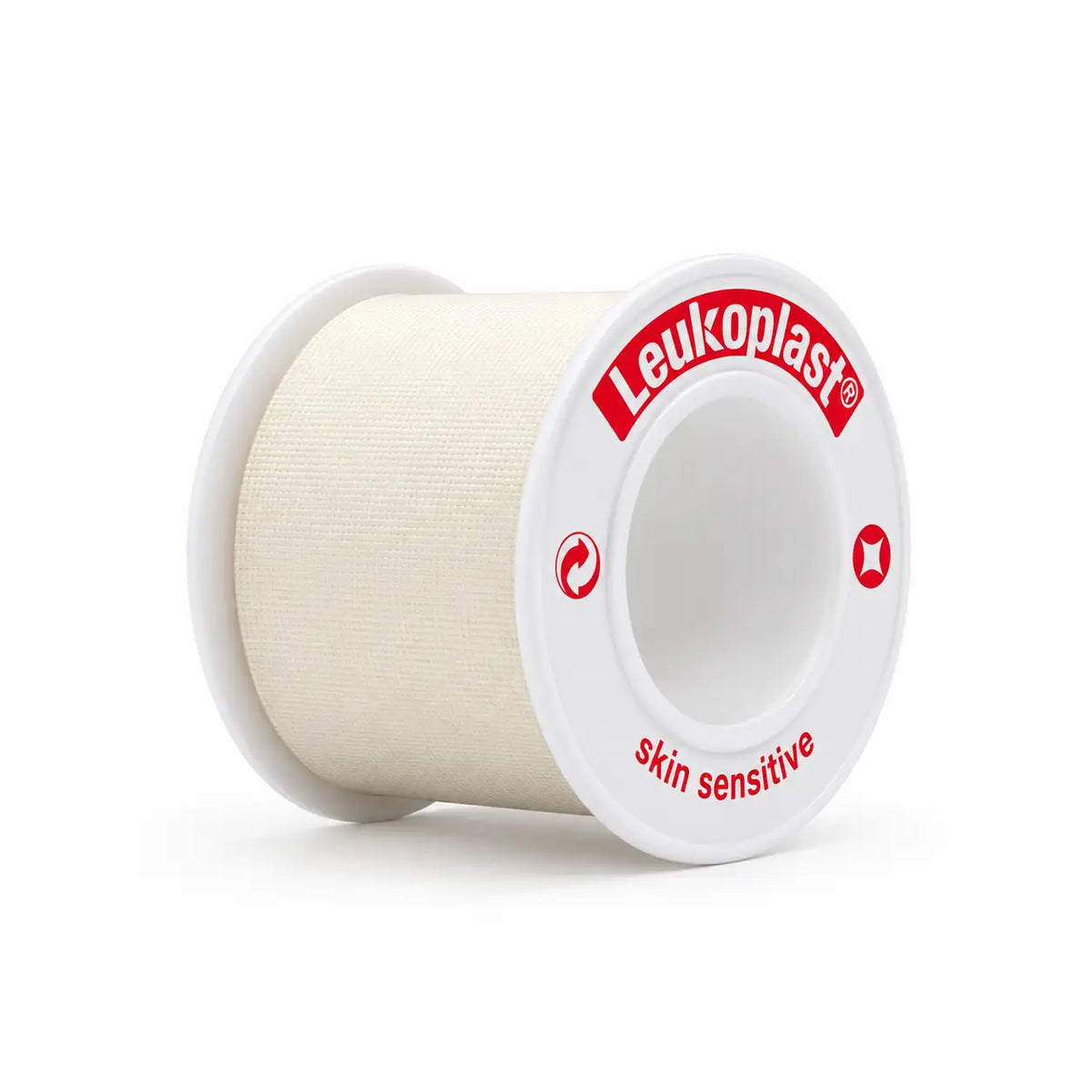 Carrete Leukoplast skin sensitive en ángulo, con la cinta de silicona color crema enrollada y el aro lateral